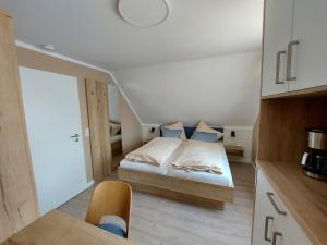 a bedroom with a bed in the middle of a room at Gästehaus am Bahnhof Norddeich in Norddeich