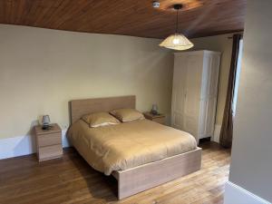 a bedroom with a bed and a wooden ceiling at Lods Hotel de France in Lods