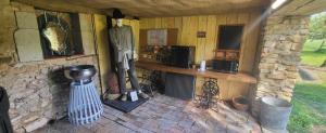 an inside of a stone building with a room with artifacts at Les cabanes du veau in Daumeray