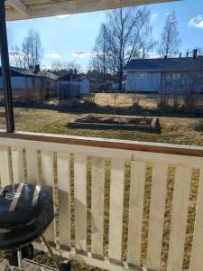 a view of a yard from a porch with a bench at Pikkurinki 28 As 2, 62300 Härmä Kauhava in Alahärmä +4 photos