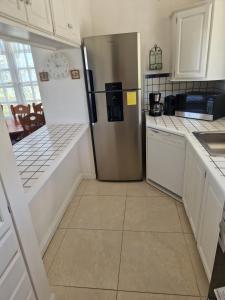 a kitchen with a stainless steel refrigerator at Villa Nirvana II in Mount Irvine