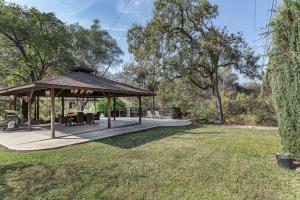 a gazebo with chairs and tables in a yard at Sequoia Riverfront House With Beach Access in Three Rivers