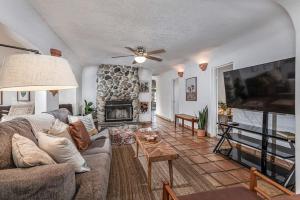 a living room with a couch and a fireplace at Sequoia Riverfront House With Beach Access in Three Rivers