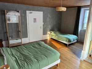 a bedroom with two beds in a room at Lods Hotel de France in Lods +6 photos