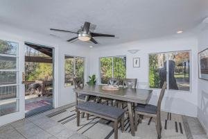 a dining room with a ceiling fan and a table and chairs at Sequoia Riverfront House With Beach Access in Three Rivers +40 photos