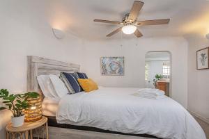 a bedroom with a bed and a ceiling fan at Sequoia Riverfront House With Beach Access in Three Rivers