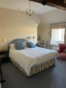 a bedroom with a large bed and a chair at The Old Stone Barn in Warrington +91 photos
