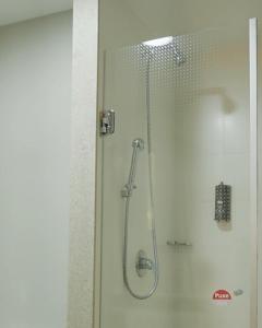 a shower with a glass door in a bathroom at ibis Tatui in Tatuí +105 photos