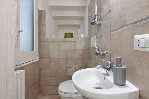 a bathroom with a sink and a toilet at Antoglietta Suites Lecce Selection in Lecce