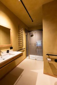 a bathroom with two sinks and a shower at La Ghiandaia Farmhouse in Conegliano +40 photos