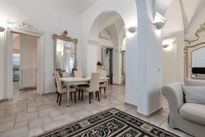 a dining room with a table and chairs at Antoglietta Suites Lecce Selection in Lecce