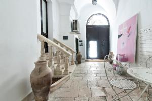 a hallway with a staircase and a vase on the floor at Antoglietta Suites Lecce Selection in Lecce +27 photos