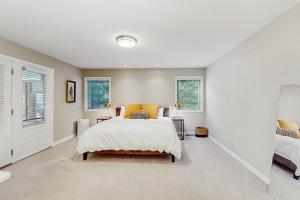 a bedroom with a bed and two windows at Leavenworth Mountain, Golf Course, 3br 4 ba in Leavenworth