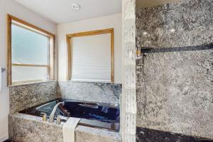 a bathroom with a blue tub and a window at Leavenworth Mountain, Golf Course, 3br 4 ba in Leavenworth +26 photos