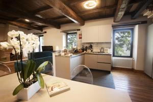 a kitchen with a table with a vase of flowers on it at Casolare Brindavan Dimora Artemisia in Vaccareccia