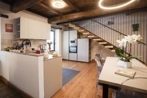 a kitchen and dining room with a staircase at Casolare Brindavan Dimora Artemisia in Vaccareccia +23 photos