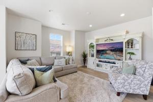 a living room with a couch and a tv at The Treehouse in Escondido in Washington