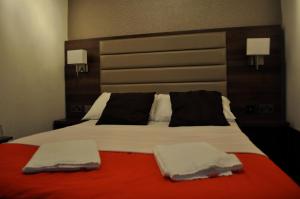 Ένα ή περισσότερα κρεβάτια σε δωμάτιο στο Goodwood Hotel