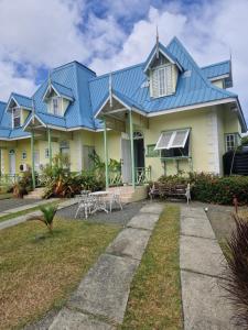 a large house with a blue roof at Villa Nirvana II in Mount Irvine
