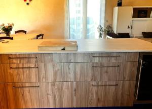 a kitchen with a large wooden counter top at Périgourdine avec spa et vue in Pomport +50 photos