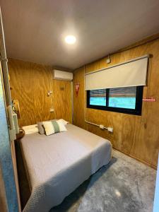 a bedroom with a bed and a window at Los Eucaliptos in Duggan