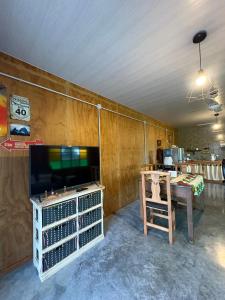 a living room with a tv and a table at Los Eucaliptos in Duggan