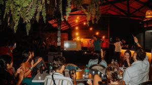 a group of people sitting at tables in a restaurant at Viajero Cali Hostel & Salsa School in Cali