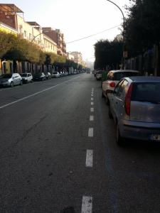 an empty street with cars parked on the side of the road at B&b La Ferrovia in Benevento