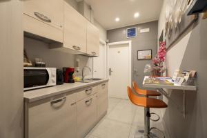 a small kitchen with a counter and a microwave at Affittacamere Orchidea for Tourists Hesperia Hosp in Modena