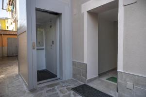 a hallway with a glass door in a building at Affittacamere Orchidea for Tourists Hesperia Hosp in Modena +41 photos