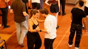 a man and woman dancing on a dance floor at Viajero Cali Hostel & Salsa School in Cali
