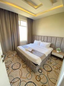 a bedroom with a large bed in a room at Golden New Alareen-جولدن العرين أبها in Abha