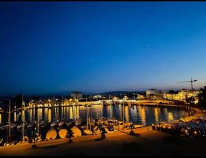 a view of a marina at night with lights at Ferien Wohnung mit Seeblick in Romanshorn