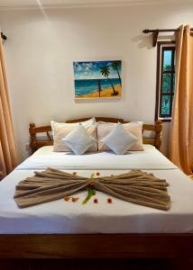 a bedroom with a bed with a robe on it at Jardin Marron in Baie Sainte Anne