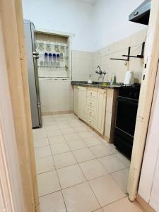 a kitchen with a refrigerator and a tile floor at la casita del altillo in San Francisco