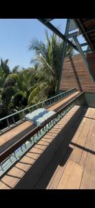 a bench sitting on top of a wooden deck at Chum Home - 02 in Danang