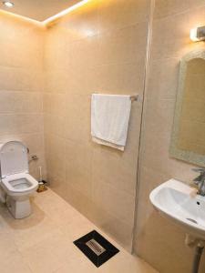 a bathroom with a toilet and a sink at Chez BABAYO BY DADES in Zaouïet Sidi Daoud +11 photos
