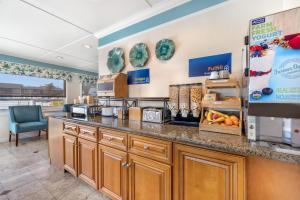 a kitchen with a counter with a coffee shop at Best Western Tradewinds in Morro Bay