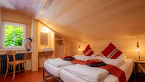 a bedroom with two beds in a wooden room at Naturfreunde Hostel Grindelwald in Grindelwald