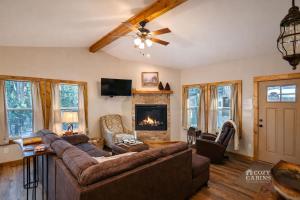 a living room with a couch and a fireplace at T-Post - A Beautiful New-Build with Treetop Deck in Ruidoso