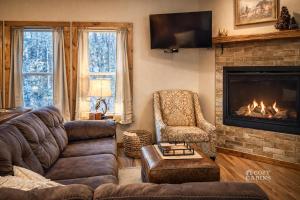 a living room with a couch and a fireplace at T-Post - A Beautiful New-Build with Treetop Deck in Ruidoso