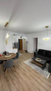 a living room with a black couch and a table at Stan na dan Bor in Bor