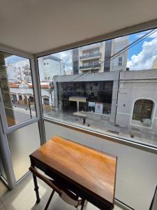 a bench sitting in front of a window at Caseros Salta in Salta