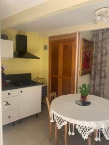 a kitchen with a white table and a table and chairs at DEPENDANCE PRIVEE - HALTE ROUTE in Le Thor