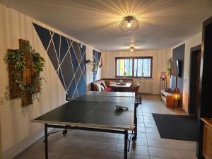 a living room with a ping pong table in it at Hotel Restaurant Raunig in Bad Kleinkirchheim