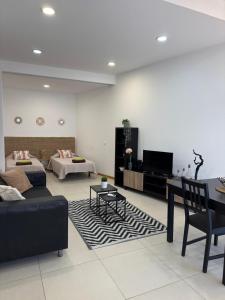 a living room with a couch and a table at Trajadinha in Vila Praia de Âncora