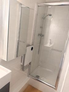 a shower with a glass door in a bathroom at Loft cosy au portes d'avignon in Les Angles Gard