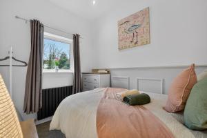 a bedroom with a bed and a window at The Oak Nest in Otford