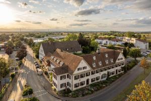 an aerial view of a large house in a town at Genusshotel Alte Post im Markgräflerland in Müllheim