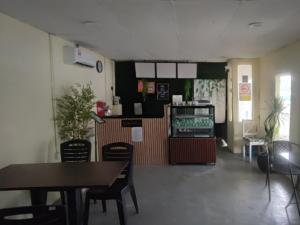 a restaurant with a table and chairs in a room at Green Forest Resort in Setiu